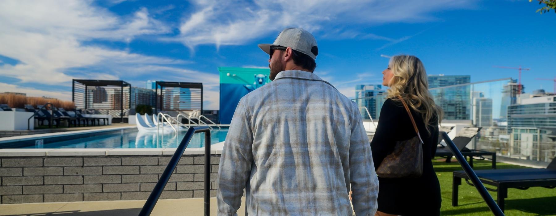 a man and woman walking on a rooftop